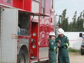 Mariah Williams and Anthony Possi check water hoses for leaks at HSE Integrated Whitecourt Station on July 22.
Celia Ste Croix | Whitecourt