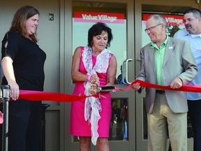 Strathcona County Mayor Linda Osinchuk cuts the ribbon to open the new Sherwood Park Value Village on Thursday, Aug. 15 while store manager Jenn Weldon and ward 1 councilor Vic Bidzinski look on. Steven Wagers/Sherwood Park News/QMI Agency