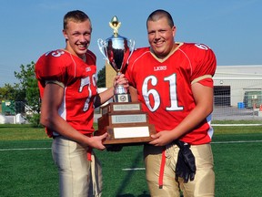 Caelan Meggs, left, and Tyden Kelly, with the OVFL championship trophy they won as members of the Cambridge Lions on Saturday in St. Catherines. (SUBMITTED PHOTO)