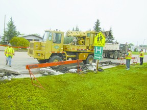 Staff of subcontractor D& H Concrete Services Ltd. of Edmonton work just west of  45 Street on the 46th Avenue (Geinger Avenue) paving project on Wednesday, Aug. 14.