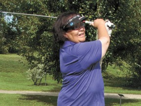 Rita Arcand of Morninville is the first of her foursome to tee off.