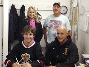 Brett Corrigan, seated, left, signs a contract with the Sarnia Legionnaires Jr. 'B' hockey club. Sitting beside him is team head coach Dan Rose. Standing are Corrigan's parents, Terry and Dan. Dan Corrigan played with the club in the 1970s. (Photo submitted by Anne Tigwell)