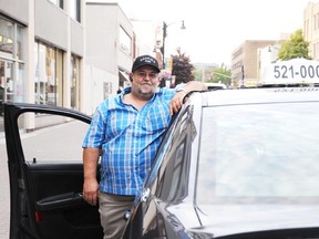 Cookie Levesque with his cab in downtown Sudbury on Monday night.

GINO DONATO/THE SUDBURY STAR