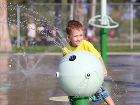 Four-year-old Tayvian Pickering cools off in the Belleville splash pad.