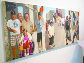 Sherri Howard, STEPAC education and event coordinator, enjoys Josepha Van Den Anker's Talbot St. in new art gallery exhibition. Eric Bunnell/QMI Agency/Times-Journal