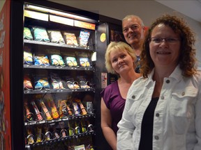 Brescia University College professor Paula Dworatzek with Anne Zok and Dave McIntosh representing Western University's Hospitality Services at a vending machine in the Support Services Building in London, Ont Aug.22, 2013. Some vending machines at Western University will be offering healthier options when students return next month as part of the Healthier4U program. SHOBHITA SHARMA/LONDONER/QMI AGENCY