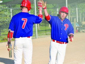 Bryce Graham of the Portage Phillies high-fives Devon Smith after a homerun during the Phillies sweep of Notre Dame Aug. 21. (Kevin Hirschfield/THE GRAPHIC/QM AGENCY)