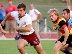 A Lindsay Griffin defender, and referee, Chris Wigley, chase a Belleville Jr. Bulldogs ballcarrier during U18 boys rugby playoff action Wednesday night at MAS 1. (Emily Mountney/The Intelligencer)