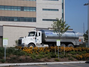 A water truck sits behind the courthouse on Coleman Street. The gardens surrounding the building will require watering by hand as the designers opted not to install an irrigation system as it would cost points under the LEED system.