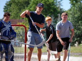 Toronto Marlies player Greg McKegg, second from left, was in his hometown of St. Thomas on Friday, Aug. 23, 2013 for a ball hockey game organized by the Talbot Teen Centre. The event was aimed at getting kids active and giving them a memorable experience. With McKegg during the game are goalie Brian Moyes and fellow players Dalton Orr and Michael Magee. Ben Forrest/QMI Agency/Times-Journal
