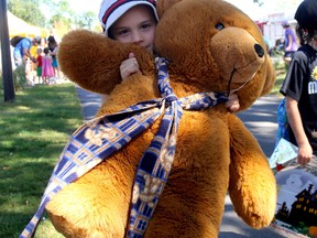 Jeremiah Head, seven, of Kingston, brings in his large teddy bear to the 19th annual Teddy Bear Picnic at Lake Ontario Park on Saturday. (Ian MacAlpine The Whig-Standard)
