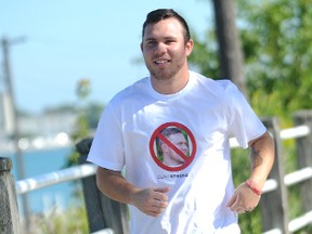 Clinton Glass, seen here with a parody "Ghost Busters" t-shirt that says, "I ain't afraid of heart and stroke," is running from Ottawa to Sarnia this September to raise money for the Heart and Stroke Foundation of Canada. The 25-year-old Sarnia resident will be journeying with his father, Gary, who had a heart attack about two years ago. (TYLER KULA, The Observer)