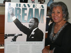 Brenda Travis poses with a poster depicting Martin Luther King and his I Have A Dream speech. Aug. 28 marks the 50th anniversary of the speech. Travis heard an earlier version a few weeks earlier in Detroit.