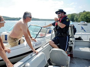 An OPP officer speaks with boaters about zero tolerance policy for alcohol while underway. - QMI AGENCY