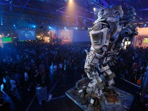 Visitors arrive at the Electronic Arts EA exhibition stand during the Gamescom 2013 fair in Cologne Aug. 23, 2013. The Gamescom convention, Europe's largest video games trade fair, ran from Aug. 22 to Aug. 25. REUTERS/Ina Fassbender