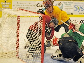 Saints hopeful, Michael Bridgeman from Stony Plain, gets taken out of the play and into the net during a scrimmage session at the Spruce Grove Saints main training camp last weekend at the Grant Fuhr Arena. - Gord Montgomery, Reporter/Examiner