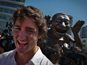 Federal Liberal Leader Justin Trudeau shares a laugh with a bronze sculpture called Laughing Man in Vancouver last month.