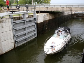 A lone boat goes through the locks at Kingston Mills on Monday morning. (Ian MacAlpine/The Whig-Standard)