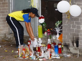 A make-shift memorial for Kwame Duodu, 15, and O’She Doyles-Whyte, 16, has sprung up at a Jane St.-Finch Ave/ housing complex. An unidentified young girl leaves a Teddy bear at the memorial. (CHRIS DOUCETTE, Toronto Sun)