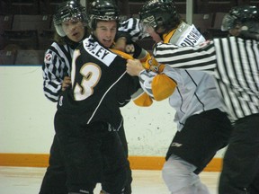 Noah Bushnell and Cam Ashley drop the mitts as they battle for a spot on the Sarnia Sting roster on Monday, August 26th. (SHAUN BISSON, The Observer)