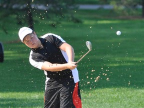 Raymond Gettler chips his ball out of the bunker during action from the Mitchell Golf & Country Club junior club championship Aug. 20.