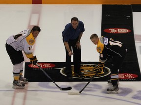 Brian Black, United Way Campaign Manager, drops the puck between Nick Latta and Vladislav Kodola before the Sarnia Sting Black and White Game on Aug 27, 2013. The game raised $2086 for the United Way of Sarnia Lambton. (SHAUN BISSON/THE OBSERVER/QMI AGENCY)