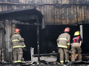 Members of Quinte West, Ont. Fire Department inspect damage to two businesses, Choice.com and Murray Rug & Tile, that were gutted by fire overnight Wednesday, Aug. 28, 2013 at 1325 Old Highway 2 in Quinte West. - FILE PHOTO: JEROME LESSARD/The Intelligencer/QMI Agency