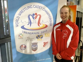 Emily Schaefer stands in front of the logo for the 2013 World Wrestling Cadet Championships in Zrenjanin Serbia. The Northern student finished 10th in the 46kg division. (Submitted photo)