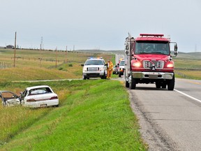 A car lies in the ditch after colliding with a truck on Highway 3. Bryan Passifiume/QMI Agency photo