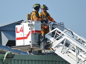 Two Tillsonburg firefighters went up in 'Ladder 4' Wednesday afternoon at 1451 Bell Mill Side Road, Tillsonburg. CHRIS ABBOTT/TILLSONBURG NEWS