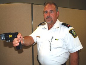 Insp. Mark Traichevich of the St. Thomas Police Service holds a Taser X26 at the police office on Wednesday. The province recently approved Taser use for all frontline police in Ontario and St. Thomas Chief Darryl Pinnell would like to see all  officers equipped with them. (Ben Forrest/Times-Journal)