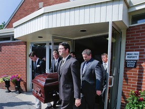 Joshua Annett, son, (front, centre) behind him is family friend, Scott McCormick and on the far left is son-in-law Gregory Lalonde, son-in-law servbe as pall bearers during the funeral for Toronto Sun Promotions Director Lesley Annett at the Church of the Epiphany in Oakville on Aug. 28, 2013. (Ernest Doroszuk/Toronto Sun)