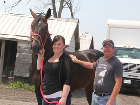 Taylor and Rusty Spitzig stand with Twin B Rawley, their prize standard bred. The Spitzigs are among many horse owners, racers, trainers and breeders who are suffering from the industry's decline. (LIZ BERNIER, The Observer)