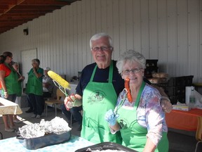 Ald. Bill Steinburg and Carol Suder, volunteer, at the Spruce Grove Agricultural Society Corn Roast. - Photo Supplied