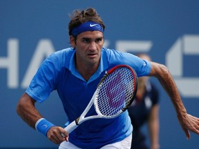 Roger Federer of Switzerland chases down a return to Carlos Berlocq of Argentina at the U.S. Open tennis championships in New York August 29, 2013. (REUTERS/Mike Segar)