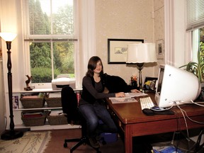 Mira Rogosin-Lavoie and her cat Nicki relax in the library of their home, the Coyne house, which was open as part of Doors Open in St. Thomas in 2010. The house, built in 1858, is located in the courthouse neighbourhood and was the home of Dr. James Henry Coyne.