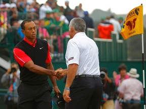 Tiger Woods of the U.S. (L) shakes hands with his former caddie Steve Williams, after finishing his final round of the British Open golf championship at Muirfield in Scotland July 21, 2013.   (REUTERS)