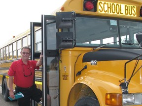 Ted Mabb, a five-year veteran school bus driver with Murphy Bus Lines in Mitchell, stands next to a school bus during a break at an orientation and training meeting for drivers at Murphy Bus Lines last week. Buses and drivers are back on the roads, ready for the new school year.