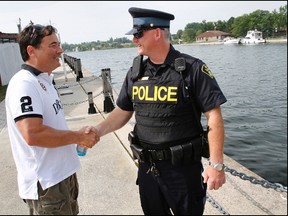 Campbellford, Ont. resident Mark Stoltz re-unites with Northumberland OPP Const. Doug Fluke in the area where the police officer rescued him from near-drowning in the Trent River Tuesday afternoon, Aug. 27, 2013, a few metres from Campbellford Seymour Fire Department, Friday, Aug. 30, 2013. - JEROME LESSARD/The Intelligencer/QMI Agency