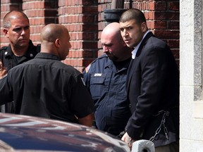 Former NFL New England Patriots tight end Aaron Hernandez, accused of killing 27-year-old semi-pro football player Odin Lloyd, is escorted from court after an appearance for a motion hearing in Attleborough, Massachusetts, August 30, 2013. (REUTERS/Dominick Reuter)