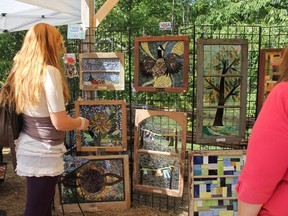 Visitors look at pieces of art at last year’s newly named Sundance Artisan Festival in Maberly, a Labour Day tradition that includes music, food and art. (submitted photo)