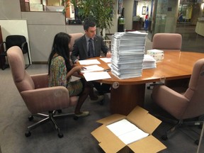 Mayor Rob Ford's staff sort through printouts of e-mails at City Hall on Aug. 30, 2013. Ford's spokesman says they have been overwhelmed by a rash of Freedom of Information requests. (Don Peat/Toronto Sun)