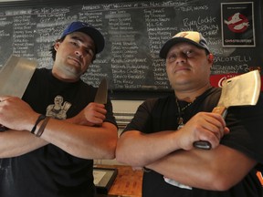 Owner Zach Davidson, left and and his working partner Jose Palma keep a list at the Meat Dept. on the Danforth. (Jack Boalnd/Toronto Sun)