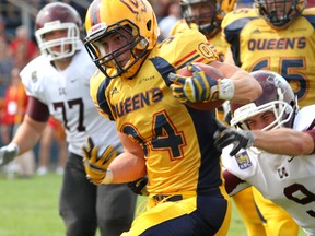 Queen's Golden Gaels Jesse Andrews runs for yardage past McMaster Marauders' Allan Dicks in Ontario University Association football action at Richardson Stadium earlier this season. Andrews and the Golden Gaels offence will be looking to get their game going Saturday against the Ottawa Gee-Gees. (Ian MacAlpine The Whig-Standard)