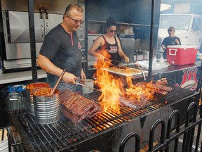 Randy Austin, of Jack the Ribber, was playing with fire at the sixth annual Downtown Sudbury Ribfest in this file photo.