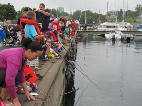 Parents and children wet the lines off the docks of Portsmouth Olympic Harbour on Saturday morning during the 2013 Kingston & District Fish and Game Club’s annual perch fishing derby. (Peter Hendra Whig-Standard file photo)