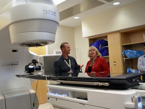 Stewart Gaede, a medical physicist at the London Regional Cancer Program familiarizes Ontario’s health minister Deb Matthews with a Varian TrueBeam radiation therapy machine at London Health Sciences Centre Sept.3,2013 in London, Ont. The province is investing in two new TrueBeam machines at the London Regional Cancer Program. SHOBHITA SHARMA/LONDONER/QMI AGENCY