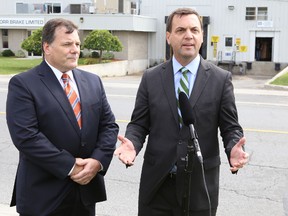 Progressive Conservative leader Tim Hudak, right, and Kingston and the Islands candidate Mark Bain, talk about their party's plans to spur manufacturing in the province during Hudak's stop in Kingston Monday afternoon.
Elliot Ferguson The Whig-Standard