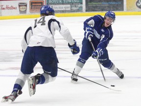 Matt Schmalz, left, of Team White, and Stefan Leblanc, of Team Blue, compete in a Wolves training camp scrimmage in September. File photo by JOHN LAPPA/THE Sudbury Star