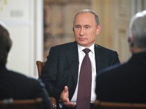 Russian President Vladimir Putin speaks during an interview at the Novo-Ogaryovo state residence outside Moscow September 3, 2013. Putin said Russia may approve a military operation in Syria if Damascus is proven to have carried out chemical weapons attacks. (REUTERS/Alexei Druzhinin/RIA Novosti/Kremlin)